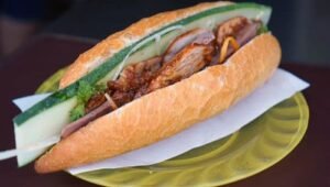 Western visitors check out the best banh mi shops in Hoi An 4